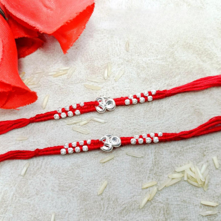 Om with 16 moti in Red & Mahroon cotton Thread Silver Rakhi