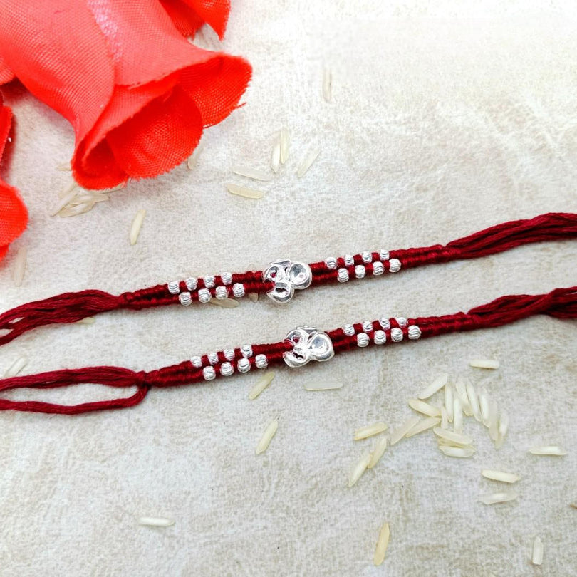 Om with 16 moti in Red & Mahroon cotton Thread Silver Rakhi