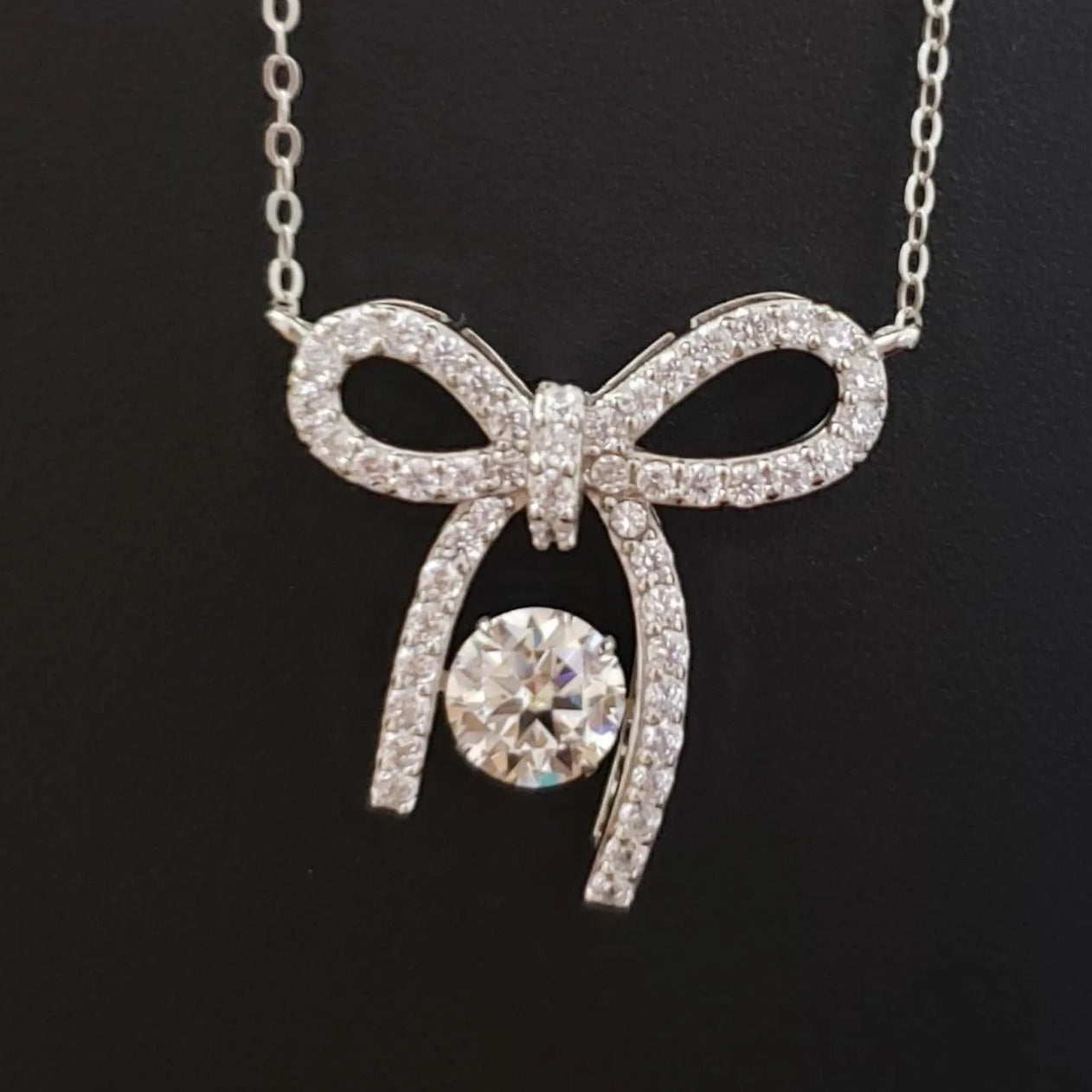 Sterling Silver Elegant Bow Pendant with Moissanite
